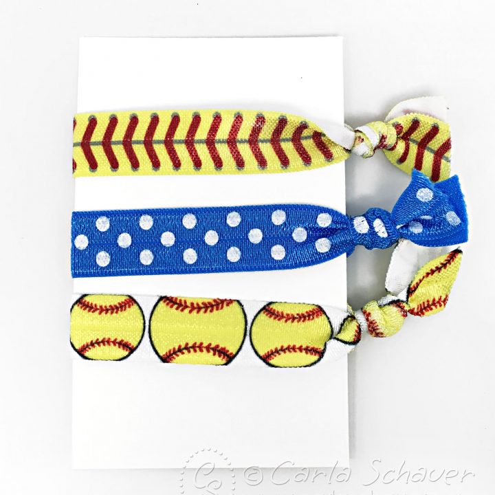 3 Softball themed elastic Hair Ties wrapped around white Cardstock